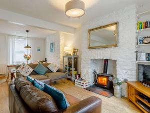 a living room with a couch and a fireplace at 3 Bed in Brixham oc-64703 in Brixham
