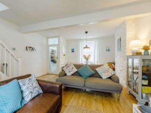 a living room with a couch with pillows on it at 3 Bed in Brixham oc-64703 in Brixham +16 photos