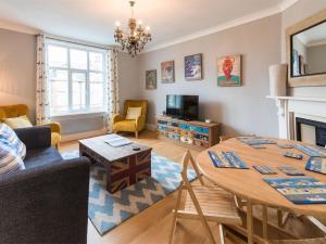 a living room with a table and a couch at 1 Bed in Harrogate oc-hh080 in Harrogate