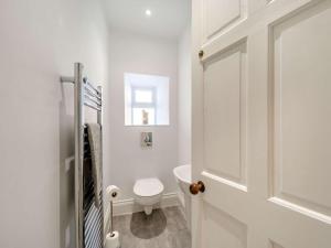 a white bathroom with a toilet and a window at 4 Bed in Hexham oc-87458 in Catton +21 photos