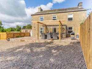 a brick house with a patio in front of it at 4 Bed in Hexham oc-87458 in Catton