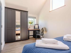 a bedroom with a blue bed and a desk at 1 Bed in Woolacombe oc-82341 in Woolacombe