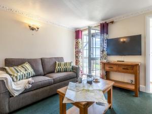 a living room with a couch and a table at 3 Bed in Braunton oc-87107 in Croyde