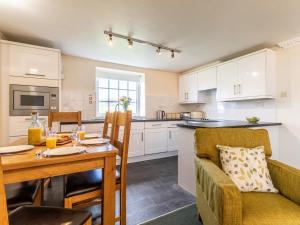 a kitchen and dining room with a table and a couch at 3 Bed in Braunton oc-87107 in Croyde