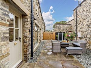a patio with a table and chairs and a door at 2 Bed in Leyburn oc-93162 in Leyburn