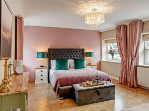 a bedroom with a large bed with green pillows at 2 Bed in Leyburn oc-93162 in Leyburn