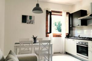 a kitchen with a table and chairs in a room at Apartment Terrarossa 2 in Fažana
