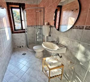 a bathroom with a sink and a toilet and a mirror at Apartment Terrarossa 2 in Fažana +8 photos