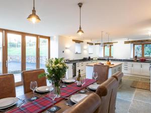 a kitchen and dining room with a table and chairs at 4 Bed in Braunton oc-62949 in Croyde