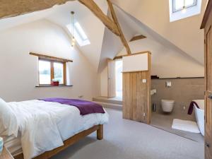 a bedroom with a large bed and a bathroom at 4 Bed in Braunton oc-62949 in Croyde