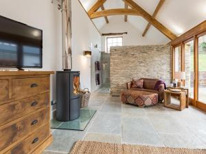 a living room with a fireplace and a tv at 4 Bed in Braunton oc-62949 in Croyde