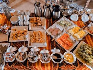 a table with many different types of food on it at Big Dipper Luxury Camp in Merzouga
