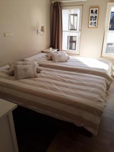 2 duże łóżka w sypialni z oknem w obiekcie Wenceslas Cobergher w mieście Scherpenheuvel-Zichem