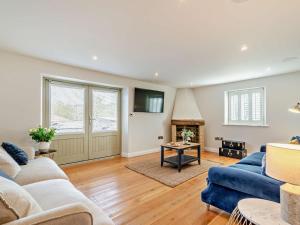 a living room with two blue couches and a fireplace at 3 Bed in Harrogate oc-91269 in Summer Bridge