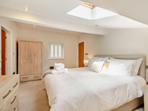 a white bedroom with a large bed with white pillows at 3 Bed in Harrogate oc-91269 in Summer Bridge