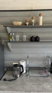 a kitchen counter with a sink and shelves with pots and pans at Гойра in Dzembronya +26 photos