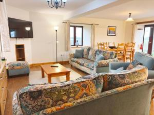 a living room with a couch and a table at 3 Bed in Bideford oc-05171 in Woolfardisworthy