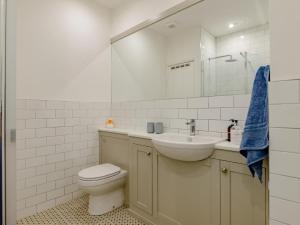 a bathroom with a toilet and a sink and a mirror at 2 Bed in Alnwick oc-78956 in Embleton +13 photos