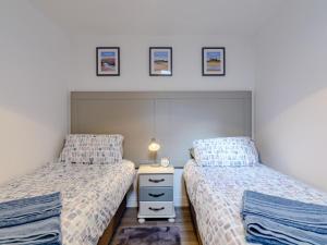 a bedroom with two twin beds and a night stand at 2 Bed in Alnwick oc-78956 in Embleton