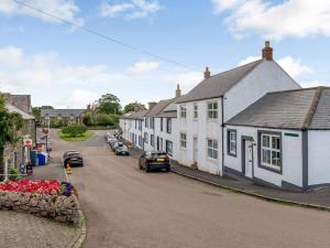a street in a small town with white houses at 2 Bed in Alnwick oc-78956 in Embleton
