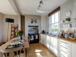 a kitchen with a table and a large window at 3 Bed in York oc-79525 in Deighton