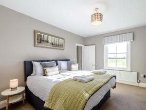 a bedroom with a large bed and a window at 3 Bed in York oc-79525 in Deighton