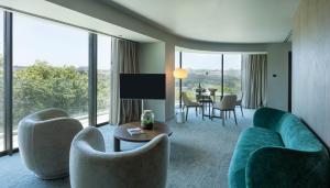 a living room with a couch and chairs and a table at Altis Porto Hotel, a member of Preferred Hotels & Resorts- LVX in Porto