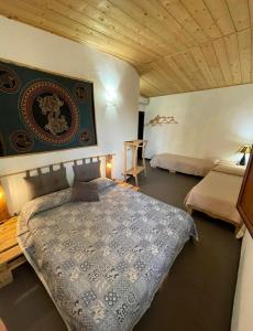 a bedroom with a bed with a blue comforter at Villa Virginia in Ragusa +88 photos