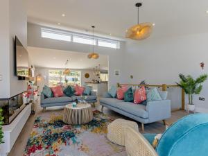 a living room with two couches and a table at 4 Bed in Appledore oc-92041 in Appledore