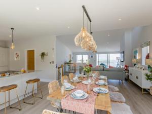 a dining room and living room with a table and chairs at 4 Bed in Appledore oc-92041 in Appledore