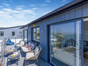 a patio with chairs and tables on a balcony at 4 Bed in Appledore oc-92041 in Appledore