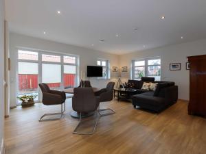 a living room with a couch and a table and chairs at Sielhof Ditzum 45263 in Ditzum