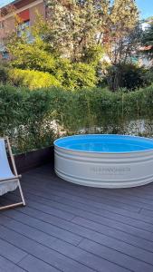 a large tub sitting on top of a wooden deck at B&B Villa Margherita - Luxury Rooms in Padua in Padova +75 photos