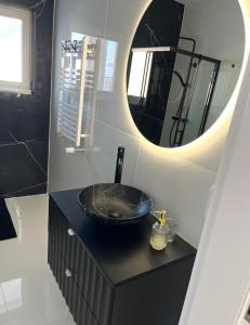 a bathroom with a black sink and a mirror at DOM LAGOWSKI z SAUNA in Łagów +13 photos