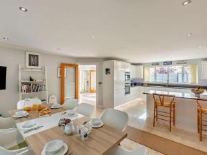 a kitchen and living room with a table and chairs at 5 Bed in Braunton oc-78250 in Braunton