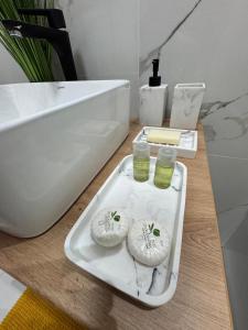 a white tray with two cucumbers on it in a bathroom at Ianmamaia in Mamaia +26 photos