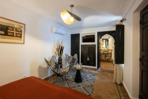 a living room with a bed and a table at Riad Dar Beldia and Spa in Marrakesh