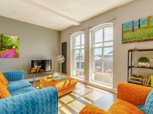 a living room with two blue couches and a tv at 2 Bed in Ripon oc-83763 in Ripon