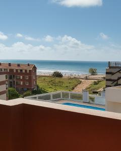 a view of the beach from the balcony of a building at Terraza Marina V in Pinamar +5 photos