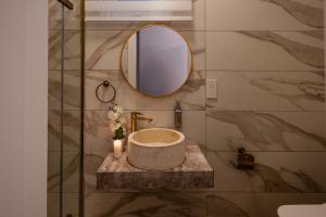 a bathroom with a sink and a mirror at St Julians`s Charm Apartments in Is-Swieqi +60 photos