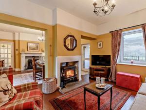 a living room with a couch and a fireplace at 3 Bed in Brampton oc-89994 in Slaggyford