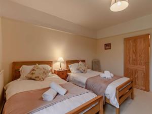 a bedroom with two beds with towels on them at 3 Bed in Brampton oc-89994 in Slaggyford
