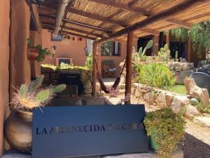 a pergola with a sign that reads la hacienda tichenor at La Amanecida Tilcara Cabañas in Tilcara