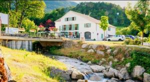 a house with a bridge over a river at L'Azimut in Senez