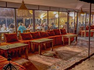 a rendering of a restaurant with people sitting at tables at Maria'S Luxury Camp in Merzouga