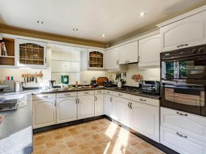 a large white kitchen with white cabinets and appliances at 2 Bed in Harrogate oc-89622 in Summer Bridge