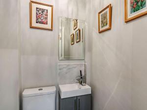 a bathroom with a toilet and a sink and a mirror at 2 Bed in Harrogate oc-89622 in Summer Bridge +12 photos