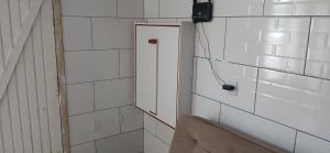 a room with a door and a mirror on the wall at Casa reformada com Wi-Fi, garagem e lavanderia in Capão da Canoa +15 photos