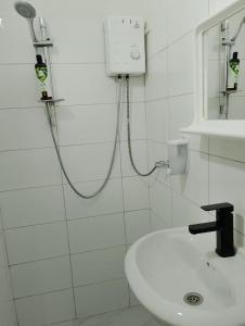 a shower in a white bathroom with a sink at GuestHouse 4 Karma369 in Plovdiv +13 photos