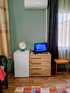 a television on top of a dresser in a room at GuestHouse 4 Karma369 in Plovdiv